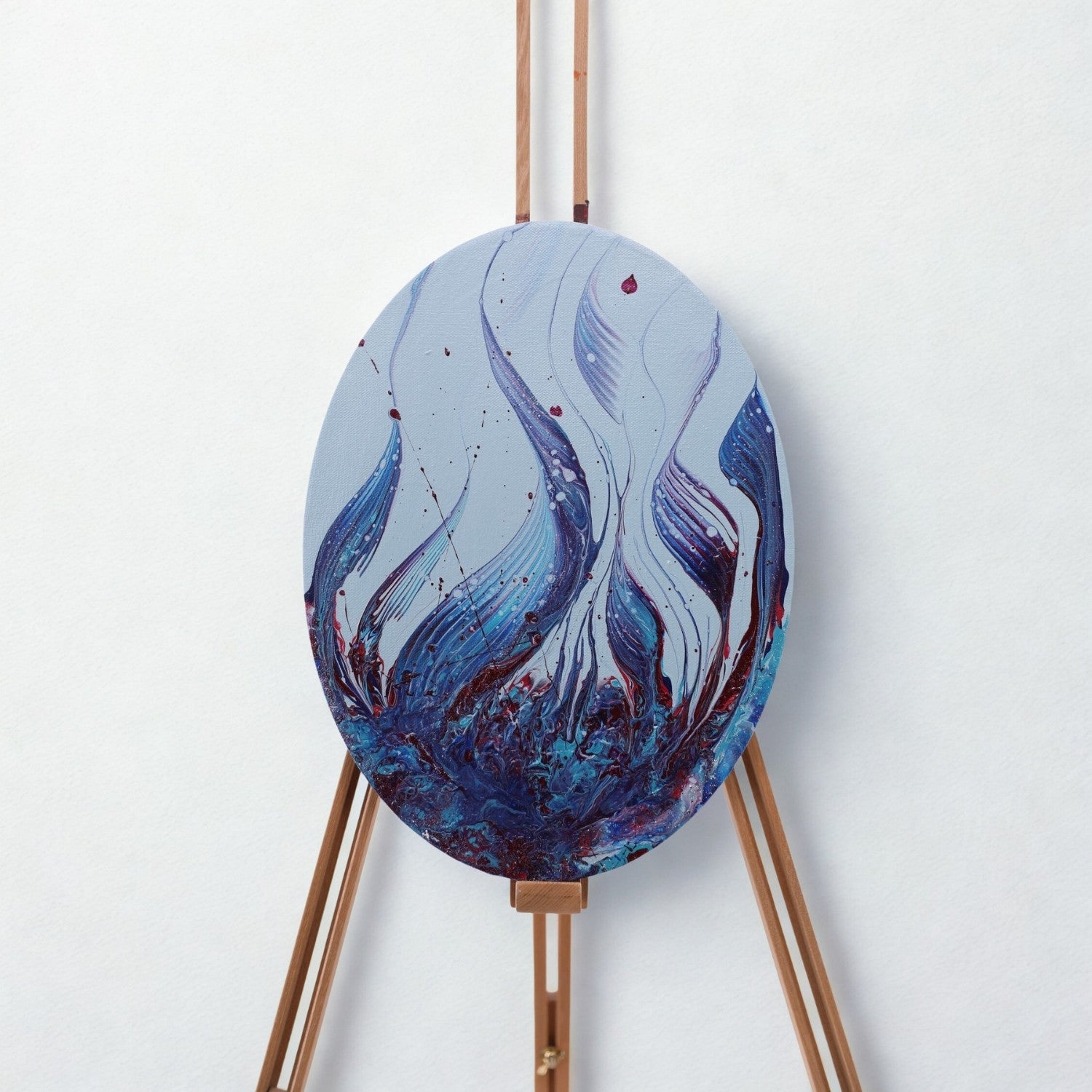 Abstraktes ovales Acrylbild mit blauen und violetten Farben auf einer Staffelei